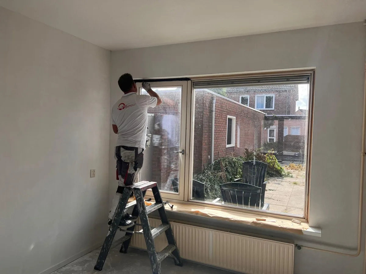 Schilder van Edison op de trapleer bij een raamkozijn